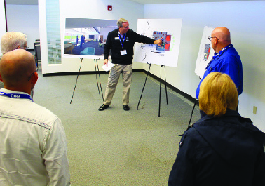 IBSA Executive Director Nate Adams shows guests the plans during the IBSA Annual Meeting in November.