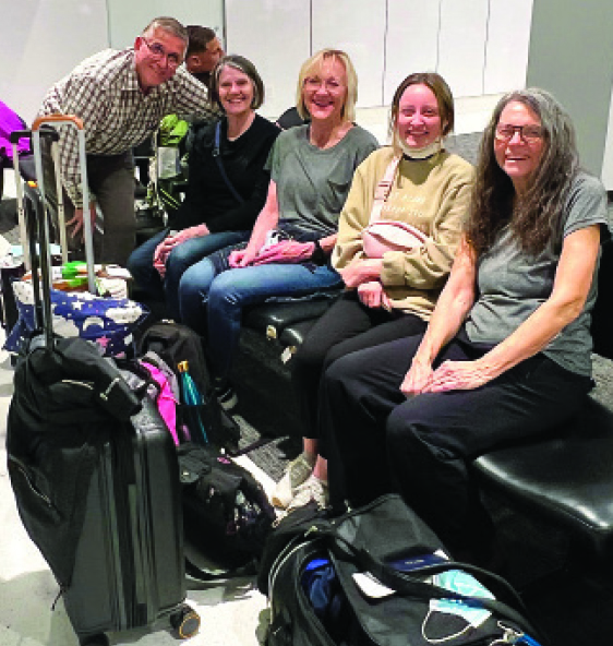 Waiting for their flight at O’Hare Airport in Chicago, Dr. Randy Oliver (left) and Tam Foster (right) met up with nurse practitioners from Georgia and Iowa and a nurse from Missouri who completed their team. 