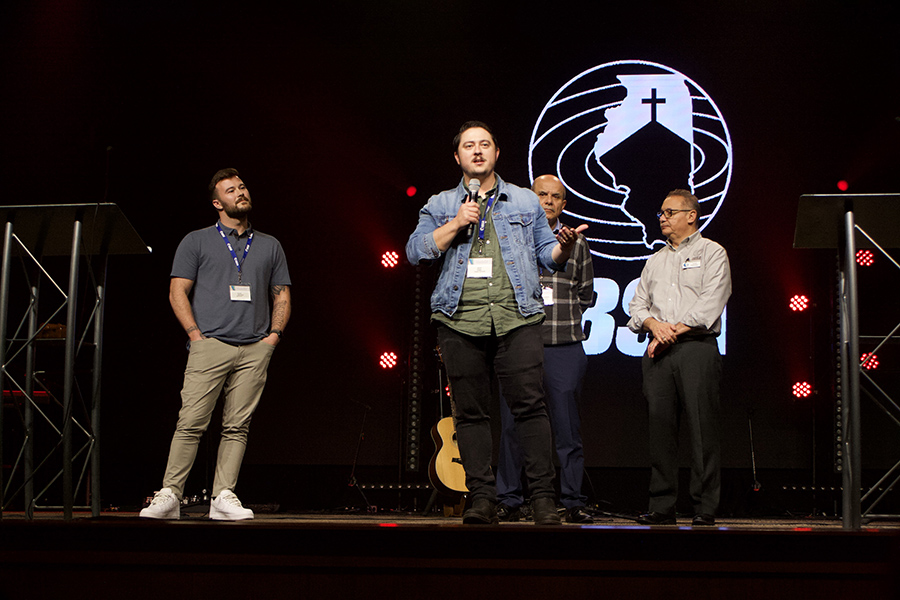 Jacob Goble (front center), planting pastor of Rooted Community Church, Lebanon, describes a town divided by state highway 4, with “have’s” on one side and “have not’s” on the other. Behind him are (left to right) Daniel Nemmers, planter pastor, Salt Church, ISU campus in Normal, Jose Nunez, pastor, Iglesia Buen Samaritano, Aurora, and IBSA’s Jorge Melendez.