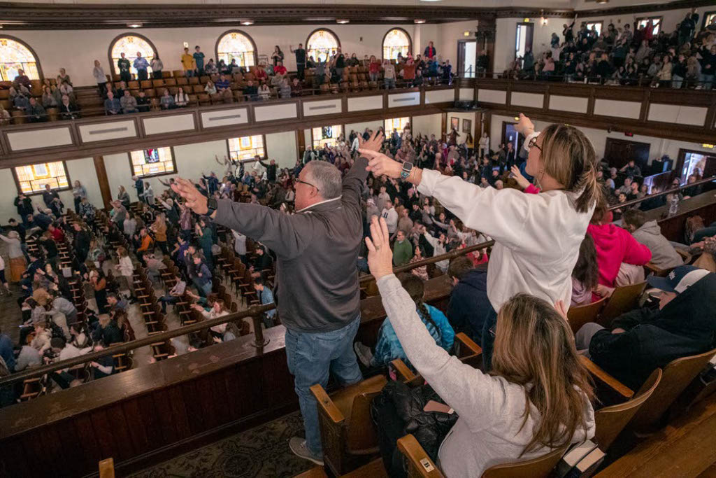 People lift their arms in worship at Asbury University in Wilmore, Ky. (Kentucky Today/Robin Cornetet)