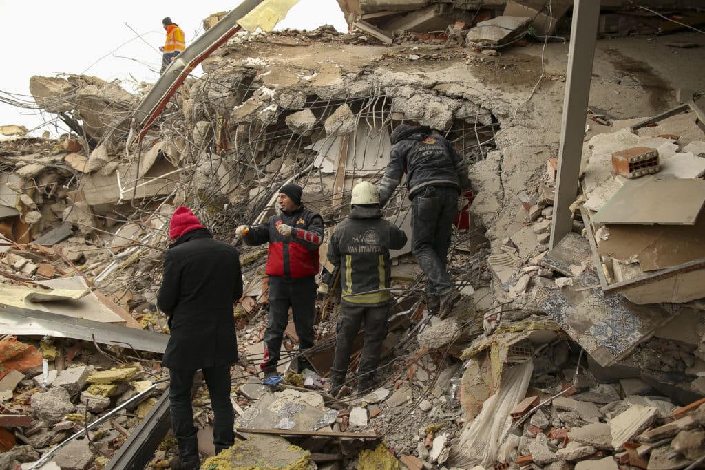 Rescue workers search for survivors on a collapsed building in Malatya, Turkey, Tuesday, (Feb. 7). Search teams and aid are pouring into Turkey and Syria as rescuers working in freezing temperatures dig through the remains of buildings flattened by a magnitude 7.8 earthquake. (AP Photo/Emrah Gurel)