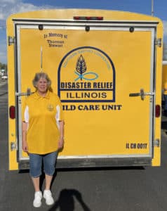 Carol Stewart, standing next to the IBDR Child Care trailer refurbished in her late husband Thurman's honor.