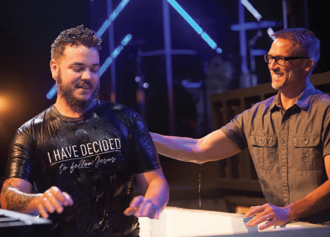 Pastor Michael Nave (right) baptizes a new believer at Cornerstone Church in Marion. IB file photo