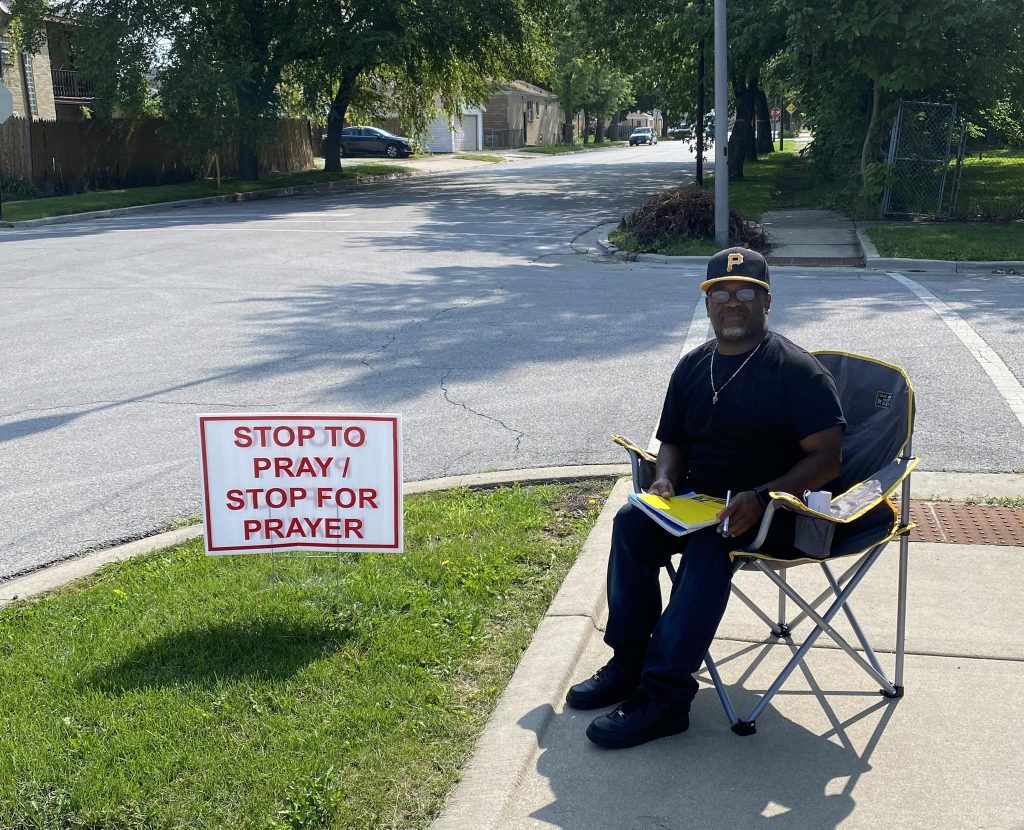 Phillip Griffin, a member of Faith Tabernacle Baptist Church in Chicago, prays for people as they pass by the church on Sunday mornings. “It feels good to let people know we are here to pray for them,” he says.