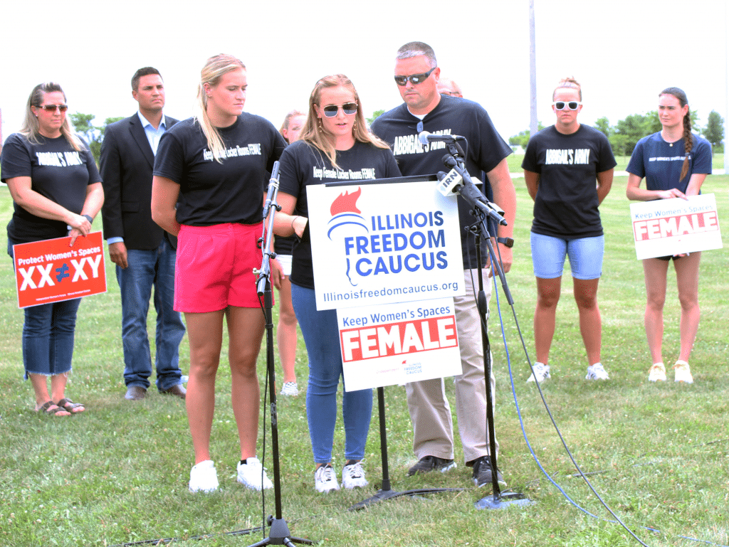 Sixteen-year-old Abbigail Wheeler speaks while surrounded by her sister, Kaitlynn, and father, Dan, at a July 13 press conference in Springfield.