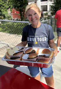 Beth Adams serves up burgers with a smile.