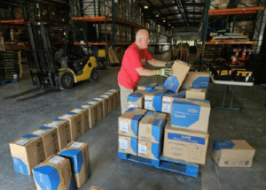 Sending relief—At the Ashland, Ky. Send Relief warehouse, a volunteer loads fire recovery supplies, including Tyvek suits, goggles, N-95 masks, and work gloves, for a shiment that left for Maui on Aug. 21. –NAMB photo