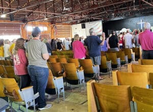 Disaster relief volunteers participate in a time of worship