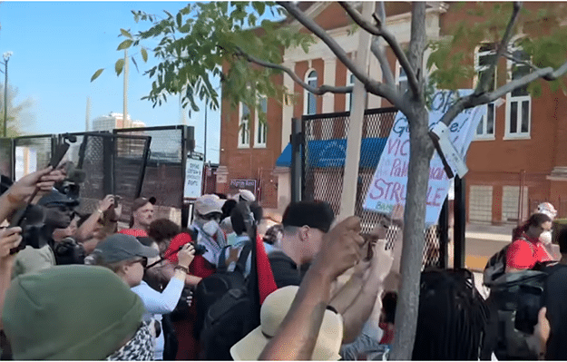 Demonstrators breach fence