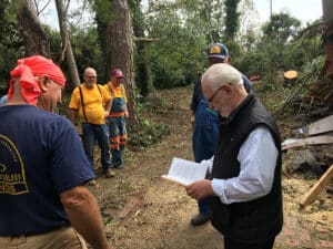 An IBDR Chainsaw Team gives a Bible to a homeowner after completing a job. Submitted photo